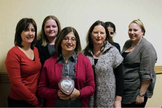 The Fields Pharmacy team with the OK to Ask plaque